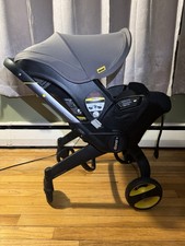 Doona Baby Stroller with Base for Car Seat Plus Rain Cover and Insect Cover