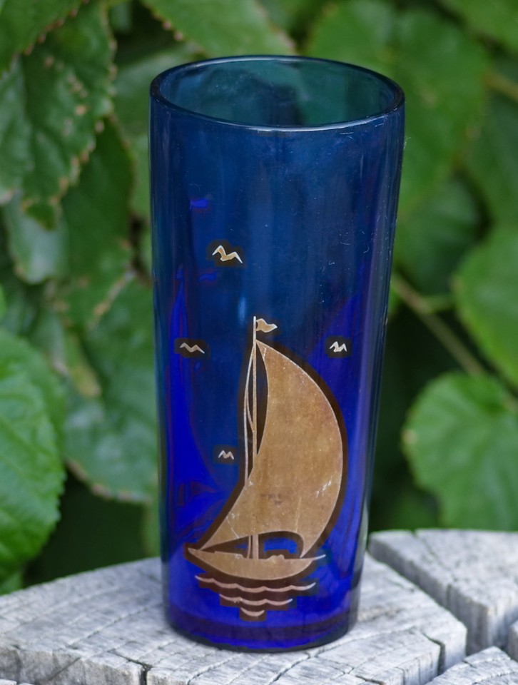 A 1940s Hazel-Atlas cocktail shaker with hand-painted sailboat motif and 22K gold trim — actual mid-century American craftsmanship you can still mix drinks in.