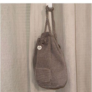 The Sak sling Backpack in the color mushroom