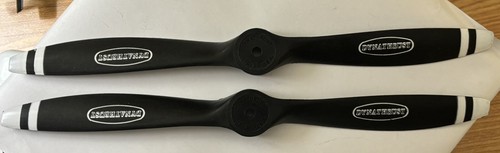 Black DYNATHRUST PROPELLER blades with white inserts, marked “13-8” and “Made in U.S.A.,” on a light gray surface.