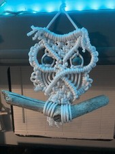 White macrame owl on driftwood