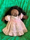 Vintage African American Cabbage Patch Kids doll with fancy white dress
