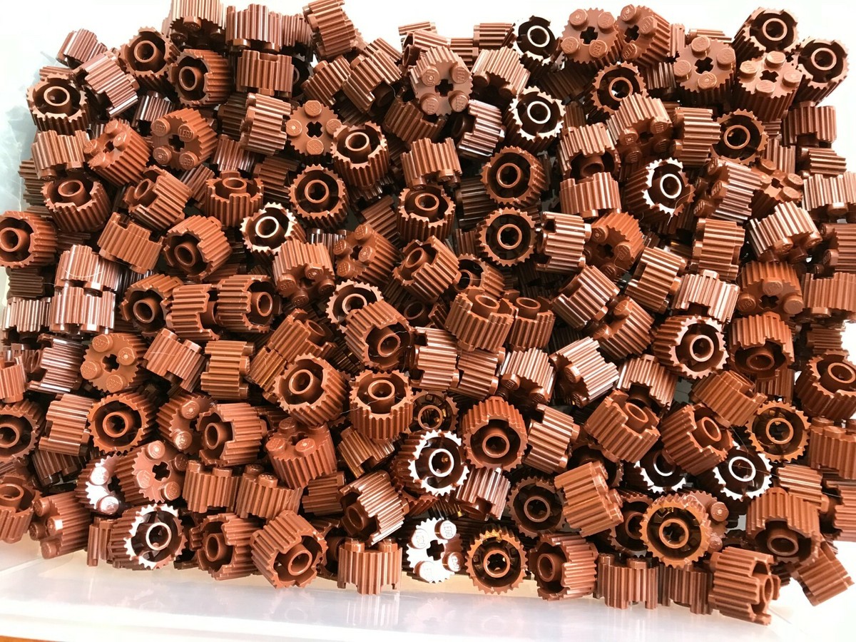 a LEGO-NEW-#92947-REDDISH BROWN- ROUND BRICK 2 X 2 W/ GRILLE/AXLE
