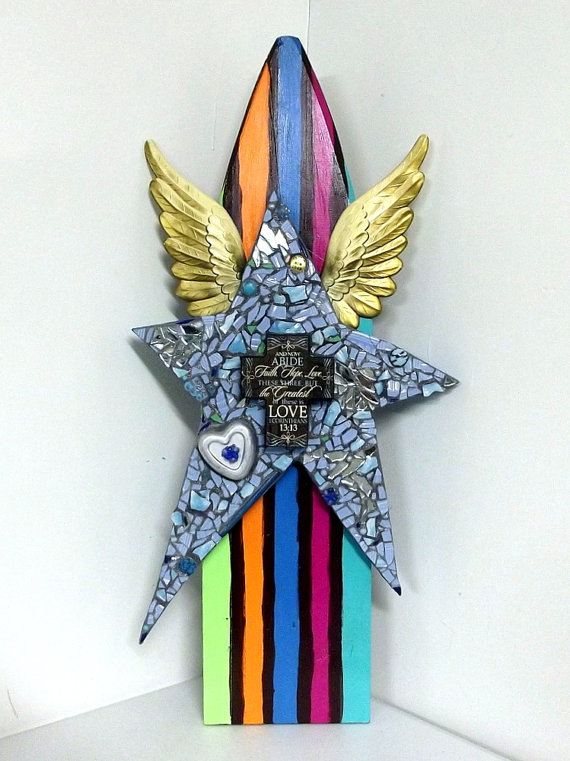 A large-scale mosaic star wall sculpture with angel wings and vintage mixed media — bold, dramatic statement art that commands a room.