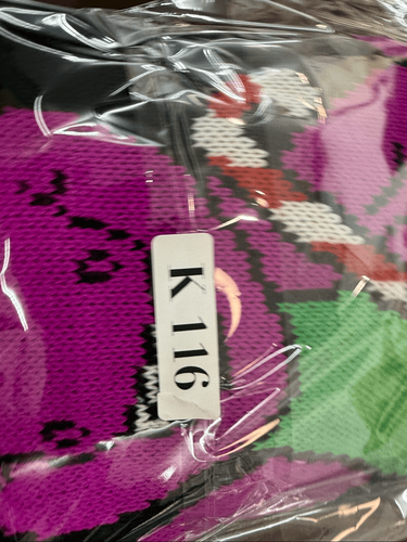 Barney Christmas/holiday sweater in purple, green, black, and red, made in USA, with white tag reading “K 116”.