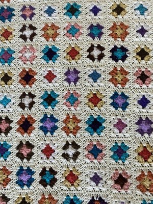 Handmade vintage crochet throw with a ''granny square'' pattern.