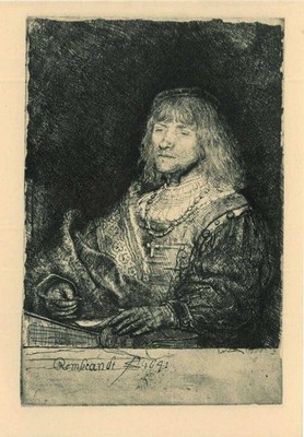 Man at a desk wearing a cross and chain