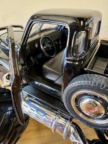 die-cast model of a Chevrolet truck modified into a monster truck Black 3100 - Picture 3 of 12