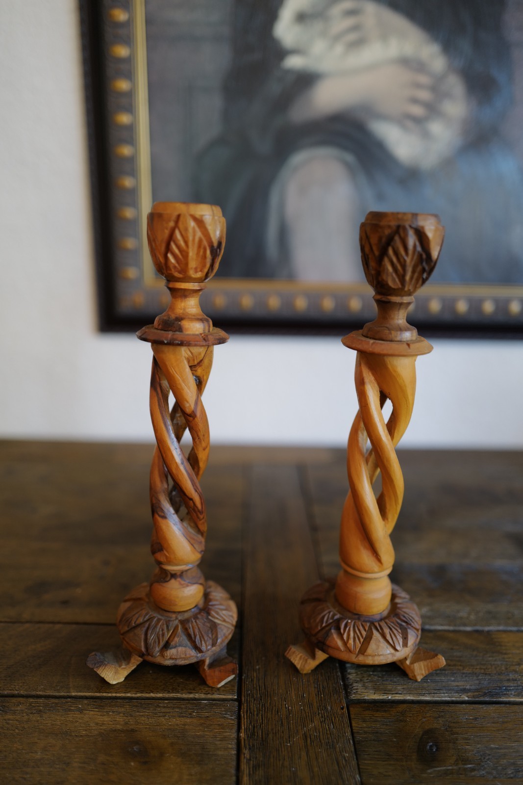 Pair of hand-carved wood candlesticks with twisted leaf design.