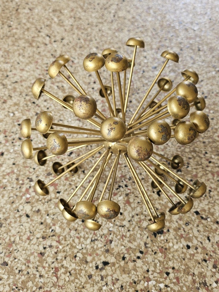 An 8" brutalist 'bloom/molecule' metal sculpture — the kind of atomic-age organic form that looks like it escaped a 1960s design museum.