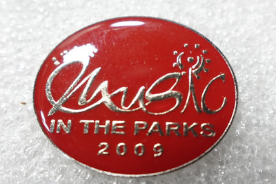 Music in the Parks 2009 Pin Red Oval Silver Text Sun Symbol Lapel Badge