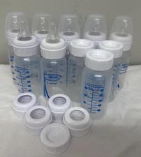 Lot Of 7 Dr. Brown’s Assorted Baby Bottles with Lids (1) 2 oz (1) 4 oz (5) 8 oz