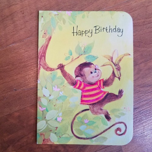 Anthropomorphic monkey swinging on tree holding banana happy Birthday by