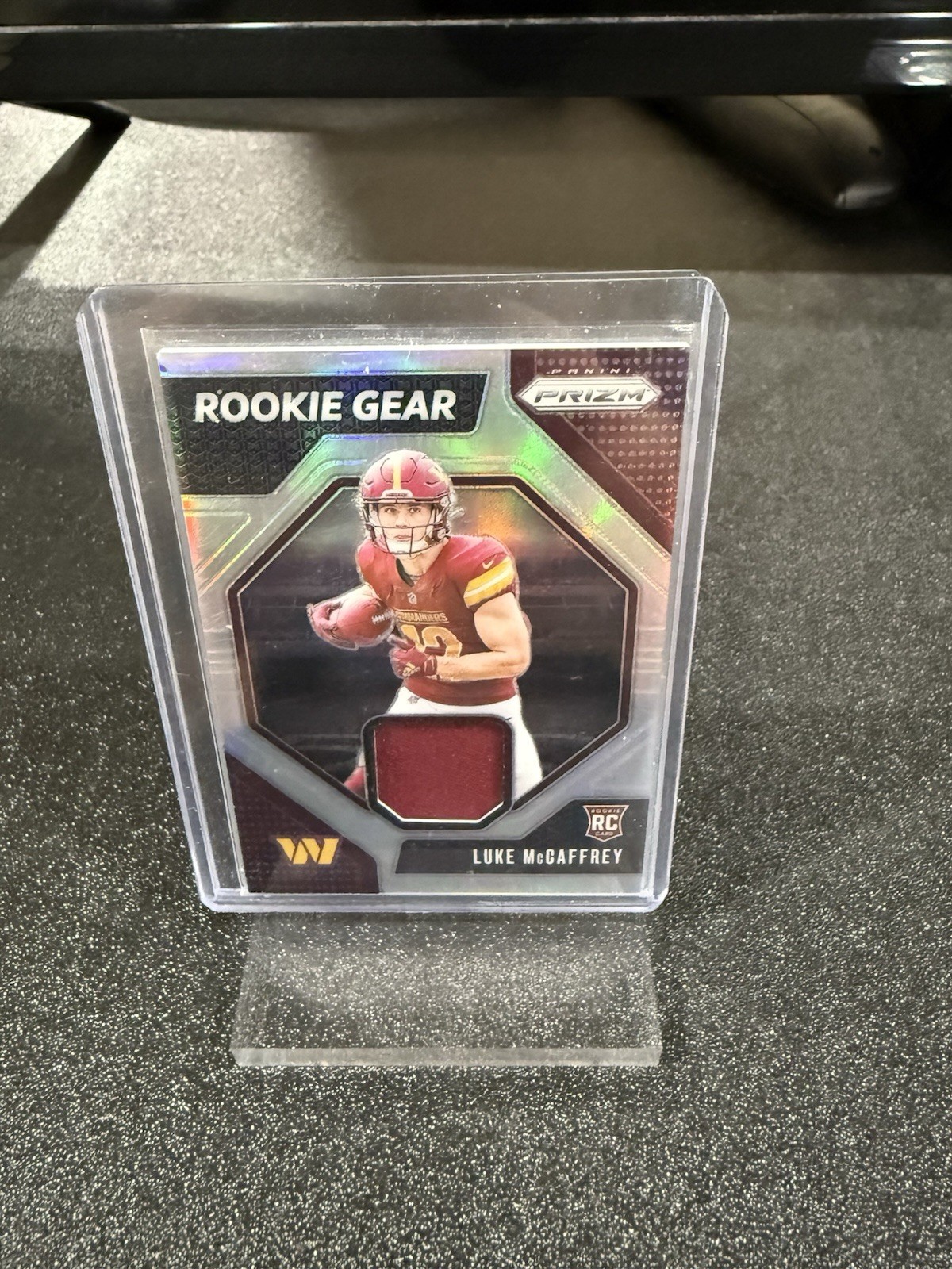 2024 Panini Prizm - Rookie Gear Luke McCaffrey #RG-LMY (MEM, RC)