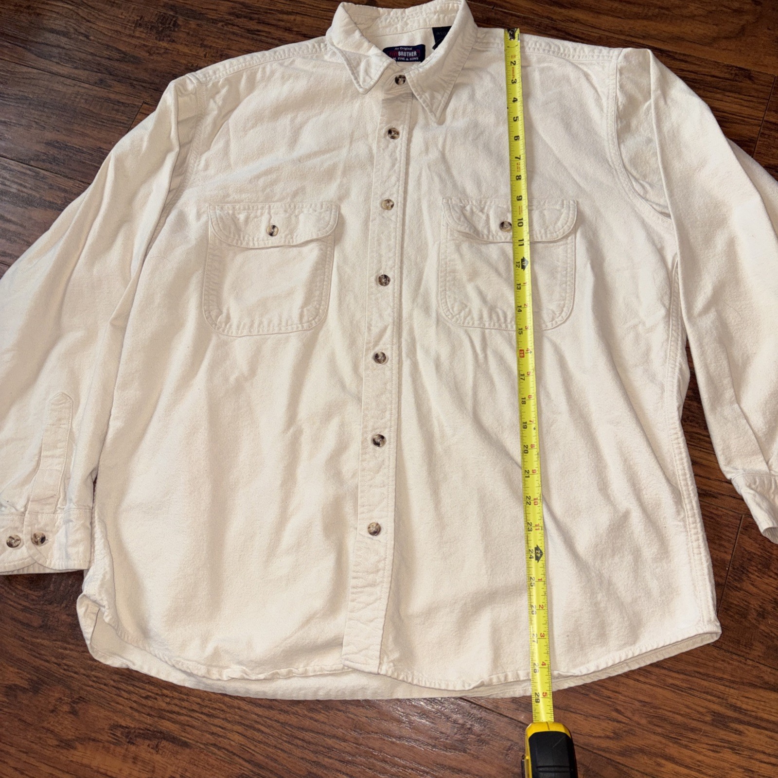 Ivory vintage five-brother flannel button-down shirt with long sleeves, two chest pockets, and yellow measuring tape.