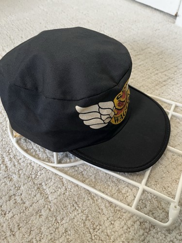 Black vintage baseball cap with white winged logo and “REO Speedwagon” text, RARE USA Made cycling cap.