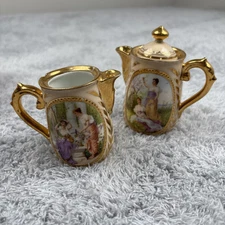 Vintage Portrait Glazed Ceramic Set of Two Pitchers 3" tall x 2" wide Crane Lid