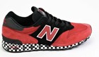 Red and black New Balance 1300AP sneaker with white “N” logo, suede panels, and black checkered base sole.