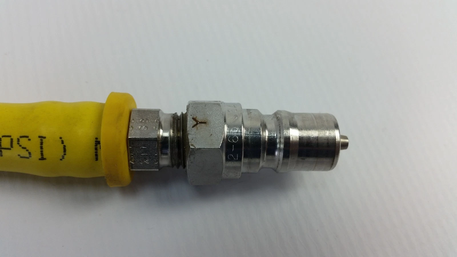 Plated quick-connect plug marked 2-63 on the end of a Parker 801-6 hose