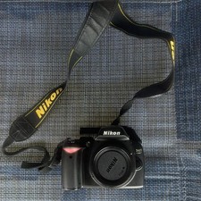 Nikon D40 Digital SLR Camera Body, bag, battery, charger, aux-to-RCA adapter.