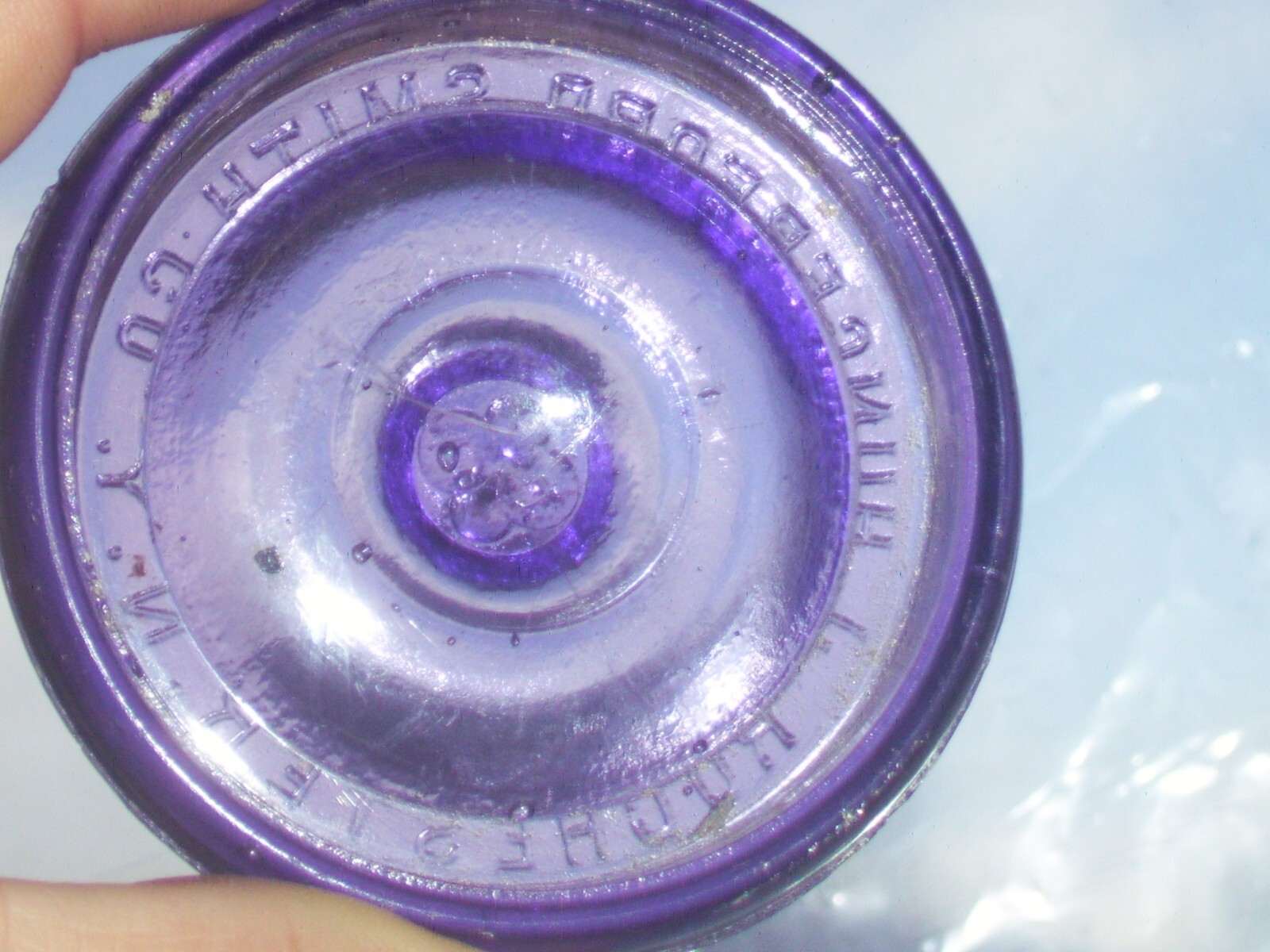 Dark purple J, Hungerford Smith co. Rochester, N. Y. glass top canning jar lid