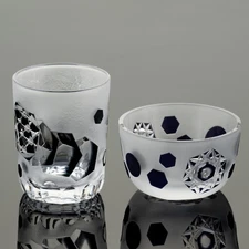 A set of two cut glass pieces with hexagonal and polygonal patterns