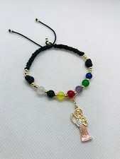 Pulsera torsal de la Santa Muerte oro laminado y piedras 7 potencias de colores