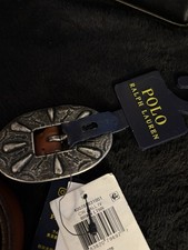 Polo Ralph Lauren brown leather belt with a western-style engraved buckle.