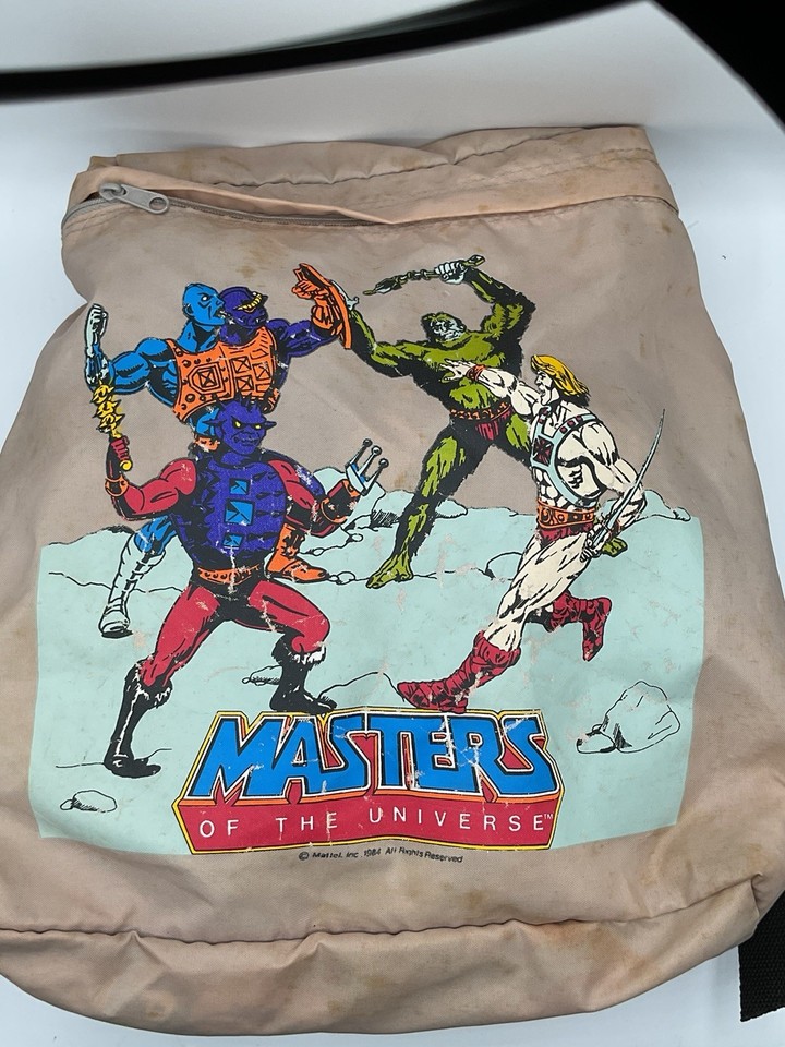 An actual vintage 80s He-Man backpack in khaki/tan is a rare, wearable nostalgia bomb that MOTU fans will absolutely lose it over.