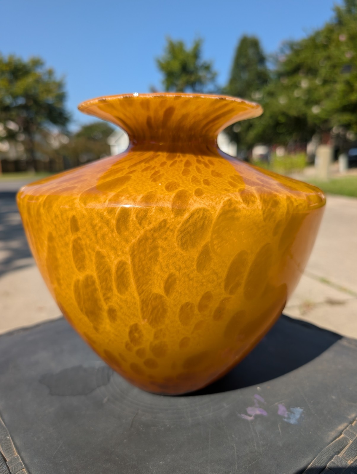 Amber and brown tortoiseshell art glass vase with a flared rim