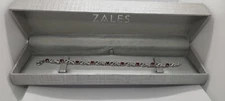 Lab-Created Ruby and 1/20 CT. T.W. Diamond Infinity Bracelet in Sterling Silver