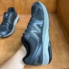 Black and gray New Balance 1540V2 men’s running shoes with mesh uppers, suede overlays, and “Made in USA” text on side.