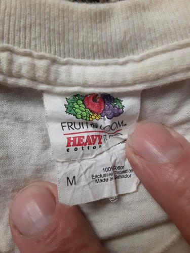 White vintage cotton T-shirt with black “GUINNESS” text, red and yellow fruit graphic, and “Osheas Cape Cod” label.