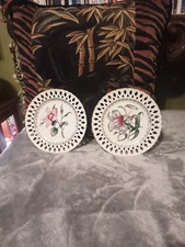 Vintage pair porcelain floral ornate decor wall plates from Japan.