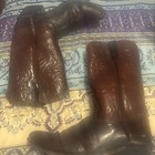 Men’s Acme leather cowboy boots, size 10.5D, burgundy and black with pointed toes, displayed on a blue paisley fabric.
