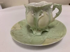 ANTIQUE MINIATURE FOOTED TEA CUP And SAUCER  ORNATE Gold Embossed Green