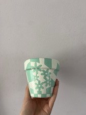 Light turquoise and white, flower and chequered print plant pot
