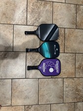 3 Pickle Ball Paddles That Are Use And The Tape On The Bottom Needs To Be Replac