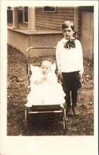 Postcard Real Photo Young Boy Standing next to Brother in Carriage RPPC