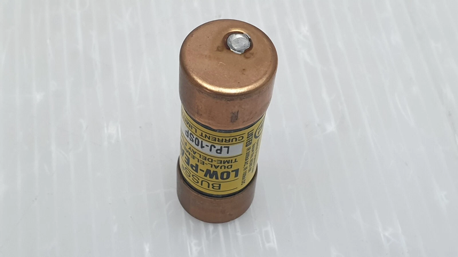 End cap of a Bussmann LPJ-10SP fuse standing upright