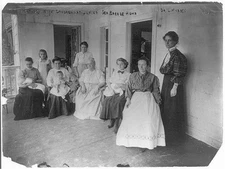 Mothers with children at Junior Sea Breese Home; Dr. L. Morden at right. New
