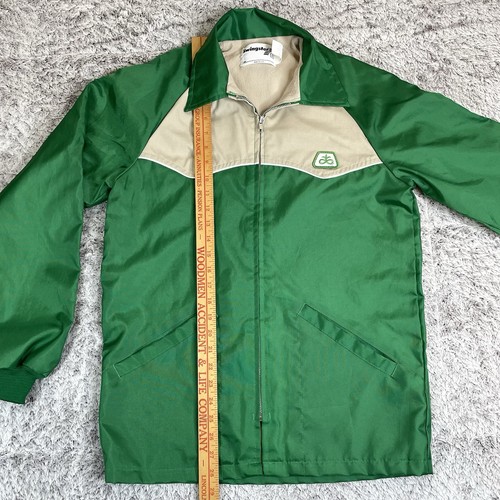 Green and tan Pioneer Seeds Swingster jacket with front zipper, pointed collar, and “ab” logo on left chest.
