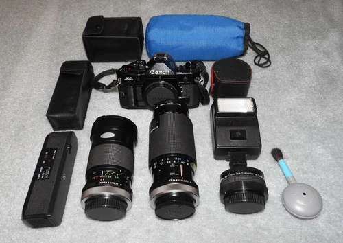 Canon Model A-1 35mm Film SLR Camera w/ Three Lenses, Pwr Winder, Flash, & More