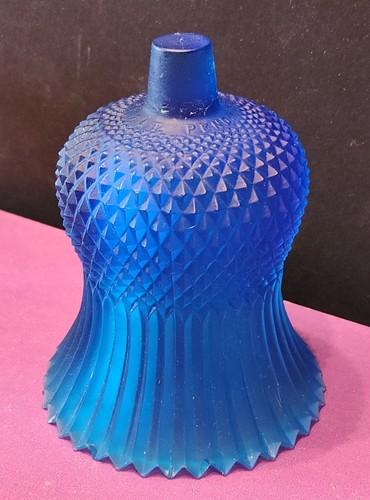 Cobalt blue vintage FAROY tulip-shaped votive candle holder with textured diamond pattern and ribbed base on pink surface.