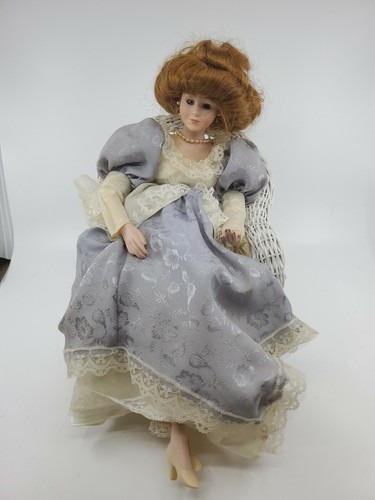 Vintage Porcelain Doll Sitting On A Chair