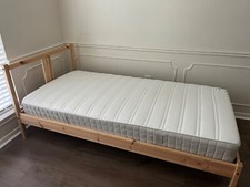 Two solid pine single beds with mattresses