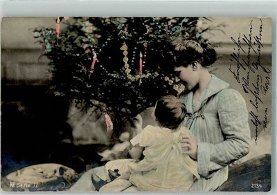 38213876 - Mother and Child Before the Light Up Christmas Tree Rotophot Series 77 No.
