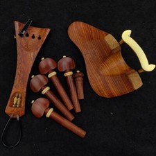 Mahogany violin accessories with hardware studs, jaws, stringboard, gut pins,