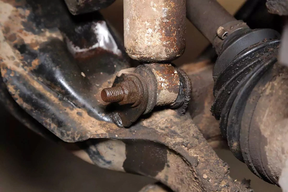 Penetrating fluid soaking into the shock absorber fastener.
