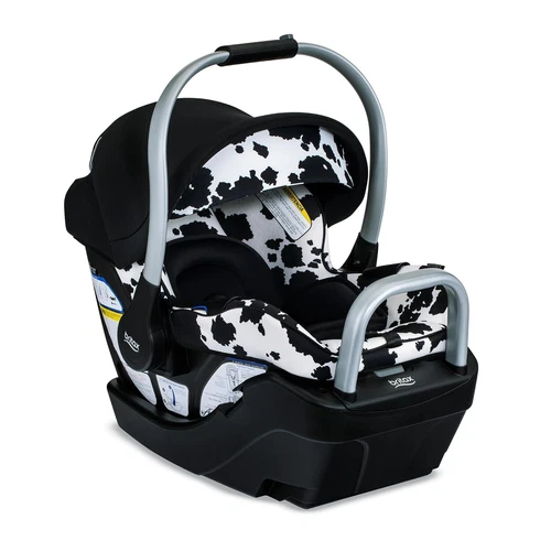 Black and white cow-print Britax Willow SC infant car seat with silver handle and visible safety labels.
